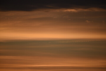 Reddish sky with lineal clouds at dusk