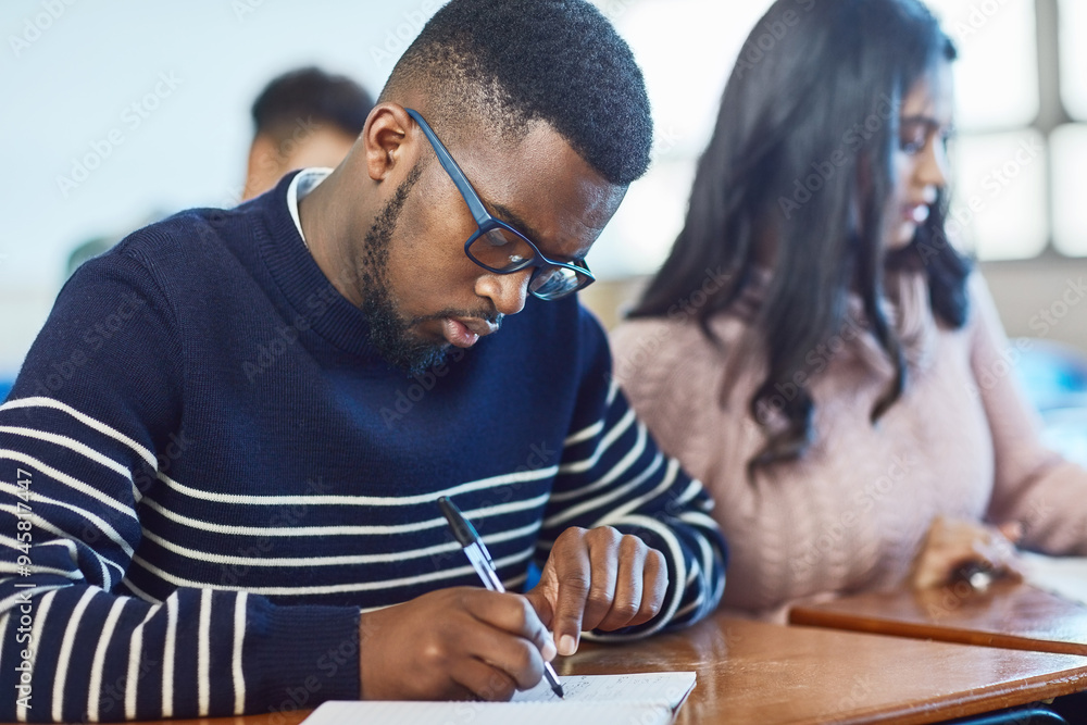 Poster University, man and writing exam in classroom for education, notes and lecture in college. Studying, group and working student ready for knowledge and learning with notebook for information and diary