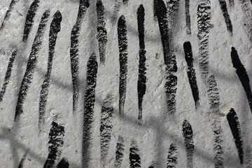 Black lines painted on a rock.
