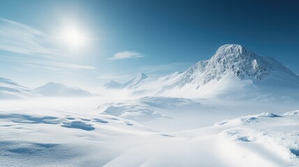 A breathtaking winter landscape with snow-covered mountains and a clear, bright sky.
