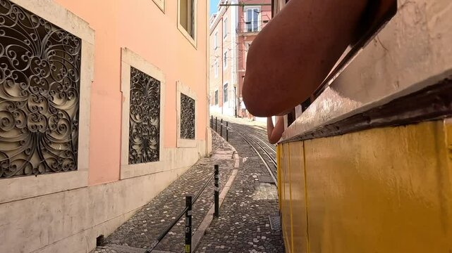 View of a passenger in the yellow Lisbon tram going up. funicular in Portugal