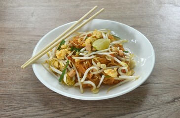 Pad Thai stir fried rice noodles with egg and bean sprout couple garlic chive on plate  