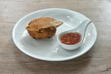 deep fried mashed crab meat and pork stuffing in shell Chinese food on plate dipping spicy chili sauce