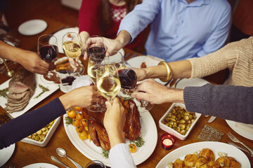 Hands, turkey and cheers with wine, thanksgiving or meat for reunion of family, dinner or celebration. Chicken, glass and alcohol for toast, holiday and gathering of people, Christmas or food in home