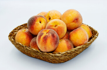 Peach, one of the most beautiful fruits of the summer season with its taste and smell, in a basket