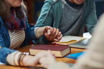 People, bible study or holding hands at table for worship, gratitude or prayer at book. Religious...