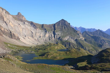 Turquoise mountain lake Barroude in French Pyrenees on HRP long-distance hiking trail