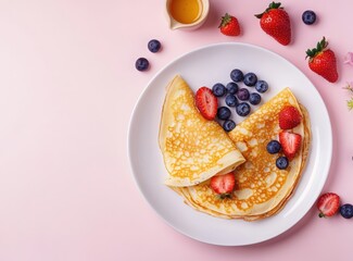 National Dessert Day. Top view of crepes with fresh blueberries and strawberries on a white plate, a honey pot next to it, pastel background. Delicious traditional Russian blini for Easter