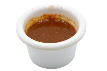 Red hot chilli pepper sauce in ceramic bowl isolated on a white background.