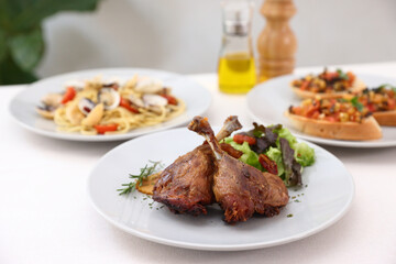 Duck leg confit with sauce. isolate in white background. top view. Duck confit on white plate