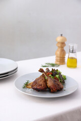 Duck leg confit with sauce. isolate in white background. top view. Duck confit on white plate