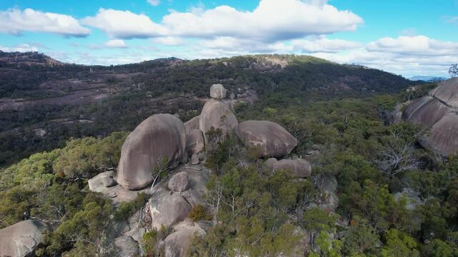 Aerial view of beautiful rock formations and boulders surrounded by lush forest and trees, Girraween National Park, Stanthorpe, Queensland, Australia.