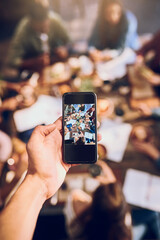 Cafe, lunch and business people with phone screen for picture, document memory and networking. Restaurant, mobile app and colleagues with food for eating, brunch and team building in creative agency