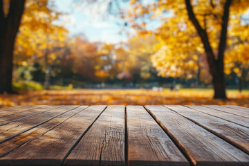 Wooden table showing autumn background with falling leaves