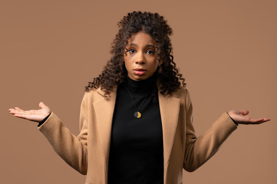 Dissatisfied indifferent african teenager girl, can't help, gesture of dont know