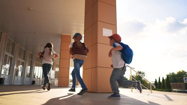 A group of girls running back to school. Bag lifestyle elementary happy. concept. Children running around in a backpack at. school. A group of children running back to school with their backpacks.