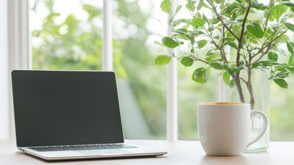 A serene workspace featuring a laptop, a coffee cup, and a vibrant plant by the window, ideal for inspiration and creativity.