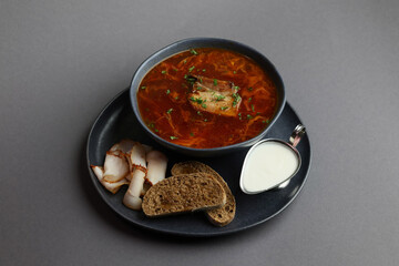 Traditional Ukrainian borscht . Bowl of red beetroot soup borscht with white cream and rye bread with lard. Beet Root delicious soup . Traditional Ukraine food cuisine
