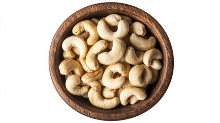 Fototapeta premium Cashew nuts in a wooden bowl, top view, isolated on a white background. Ideal for promoting natural and healthy foods.