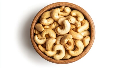 Fototapeta premium Cashew nuts neatly arranged in a wooden bowl, isolated on a white background, top-down view. Perfect for food advertising.