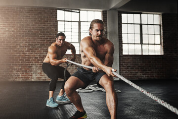 Obraz na płótnie Canvas Man, training and exercise in gym with rope for fitness, workout and muscle growth, agility and power. Body builder, pull and tug of war in sports club for strength, health and speed with resilience