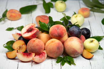 Peaches and apples on wooden background