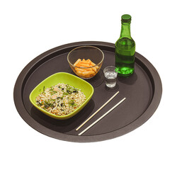 Korean dinner with ramyeon noodles, tteokbokki, green bottle of soju and chopsticks on a black tray isolated