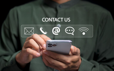 Contact us or the Customer support hotline people connect. Businessman using mobile phone and using hand touching virtual icons call phone, email, address, and live chat. Customer service call center.