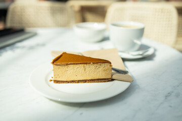 Classic New York cheesecake on a white concrete background, side view. Tasty cheesecake with...