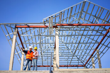 Fototapeta premium Blue collar workers are building house.