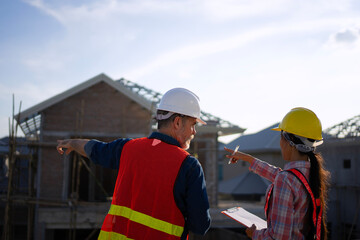 Blue collar workers are building house.