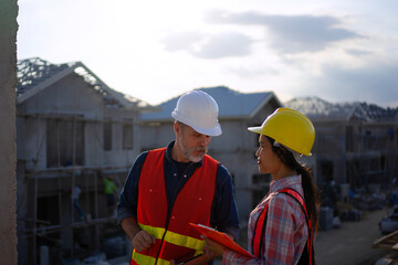Blue collar workers are building house.