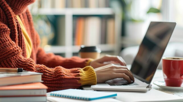 An adult learner working on a laptop at home, attending an online class with study materials nearby