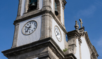 Sao Martinho de Lordelo church tower with clock and tiles decoration in Porto, Portugal. Close-up