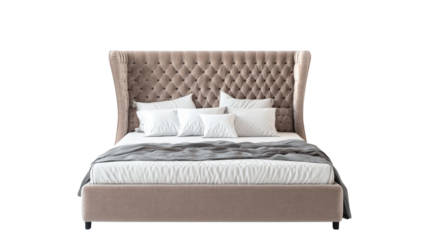 Luxurious upholstered bed with tufted headboard, featuring soft pillows and cozy blanket, creating warm and inviting atmosphere. 