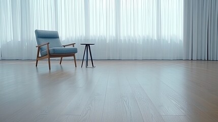A stylish minimalist living room showcases a grey armchair beside a window, with soft white curtains filtering natural light, and a sleek coffee table adds functionality