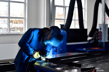 Workers welding in workshop, factory