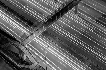 Obraz premium Vibrant Night Cityscape Featuring Illuminated Skyscrapers, Busy Highway, and Twinkling City Lights, Capturing the Essence of Urban Life and Modern Architecture After Dark