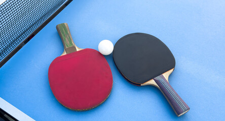 tennis rackets for playing ping pong on blue table, ping pong concept, active sports