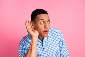 Photo of funky sly guy dressed checkered shirt listening gossips emtpy space isolated pink color...