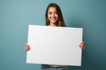 Smiling Woman Holding a Blank White Poster