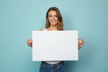 Woman Holding Blank White Sign Against a Light Blue Background