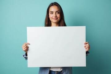 Young woman holding a large blank white sign