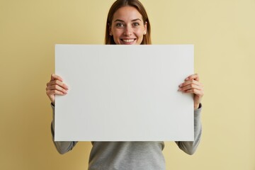 Woman Holding a Blank White Sign with a Smiling Expression