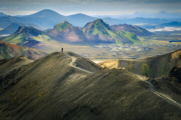 A hiker on a trail in Landmannalaugar, Icelandic Highlands, adventure concept