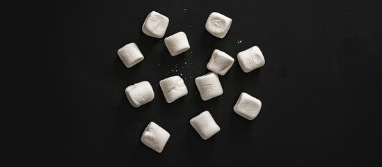 Top view of sweet classic marshmallows set against a black background. Copy space image. Place for adding text and design
