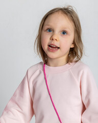 Portrait of beautiful cute little toddler girl. Pretty smile kid in studio on light background. High quality photo