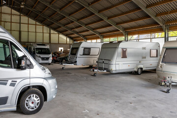 Caravans and campers from private individuals in a large shed at a farm