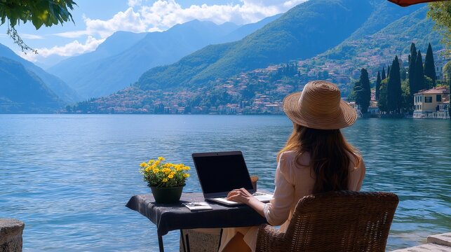 A happy digital nomad freelancer who work remotely from a laptop on the shores of Lake Como, Italy, in a flexible and active work environment with beautiful scenery. Replication space
