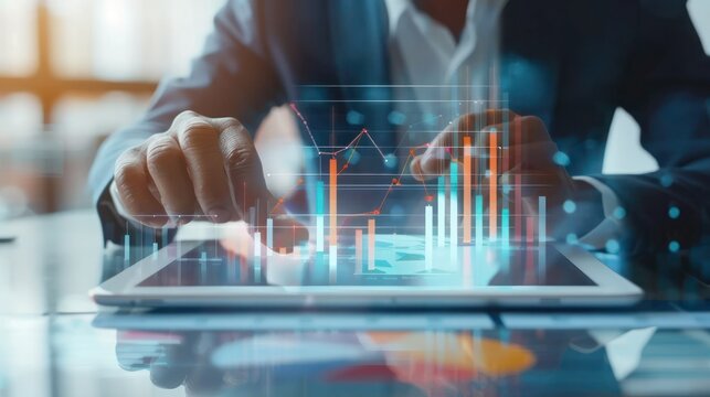 Businessman using tablet analyzing sales data and economic growth graph chart. 